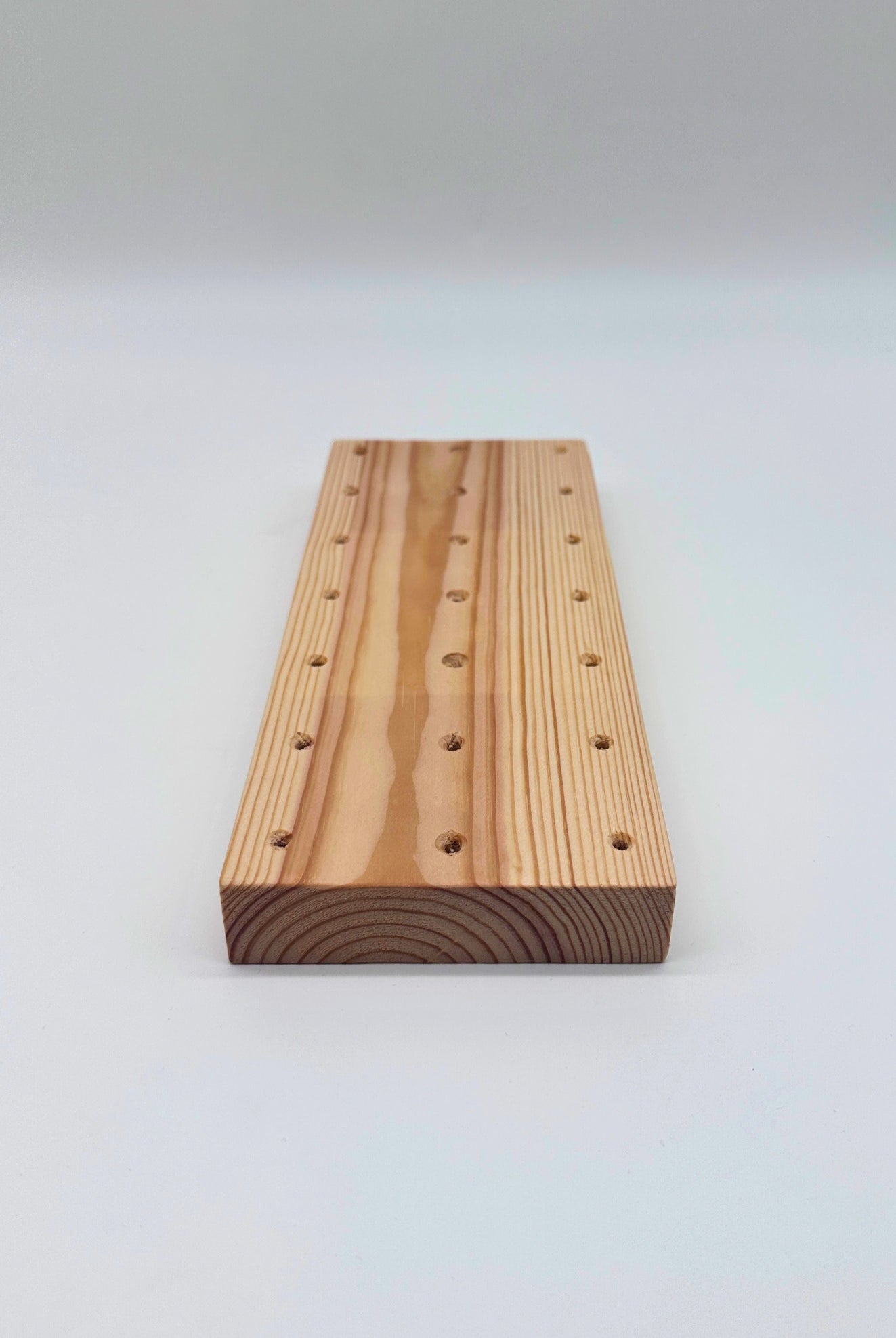 Wooden block with holes on a white background