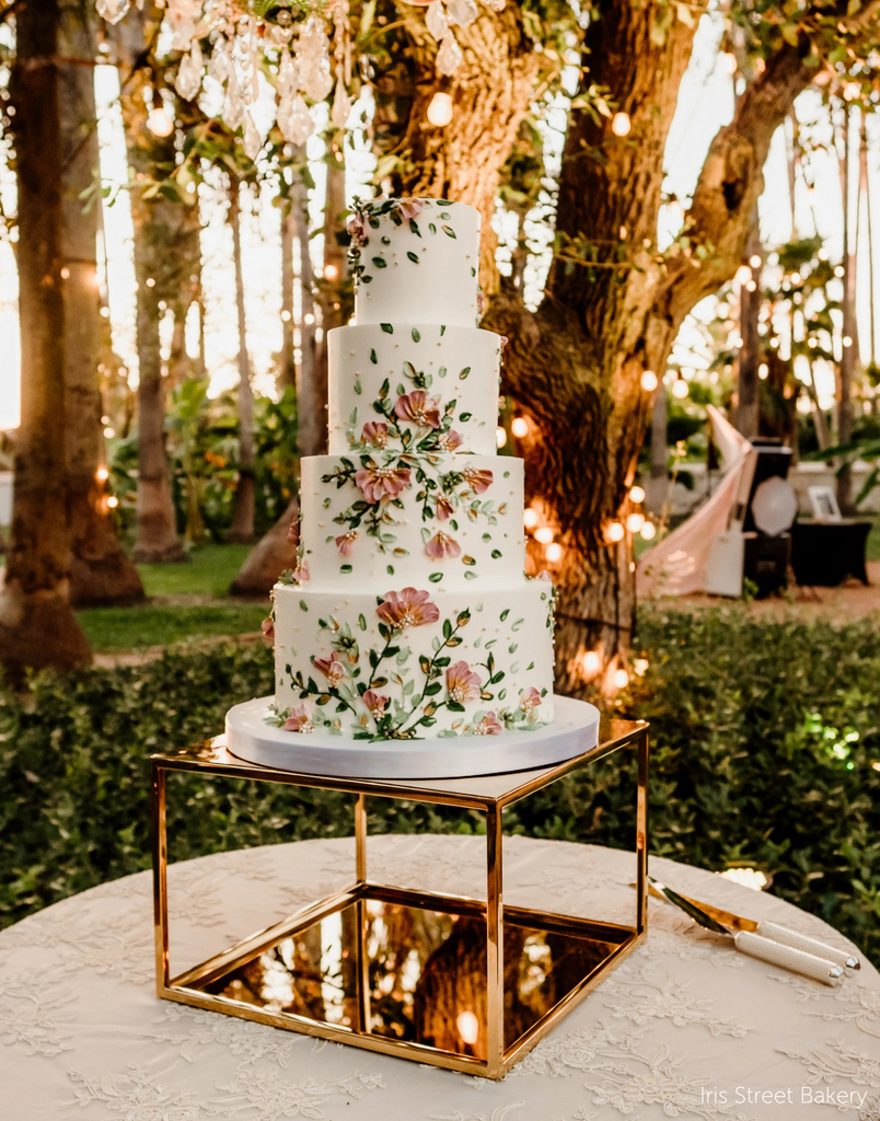 Gold Square Metallic Plinth holding up a multitiered wedding cake with floral decorations - Prop Options