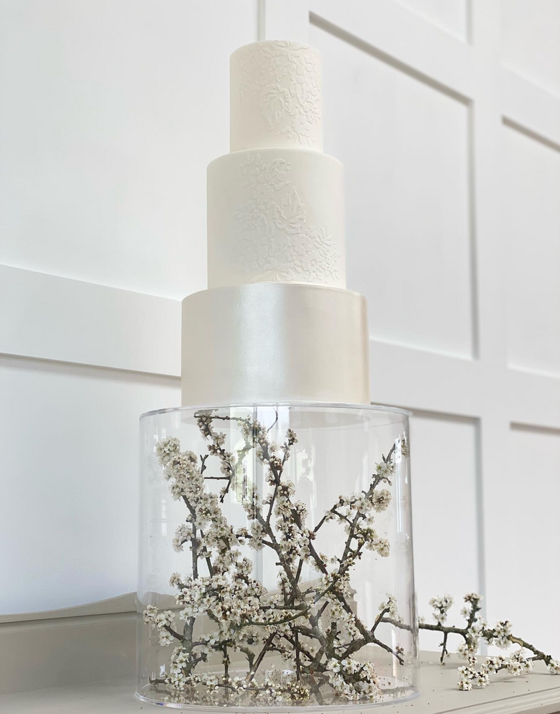 Round Acrylic Fillable Plinth filled with flower branches - Prop Options