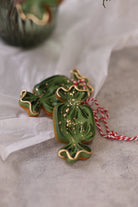 Green candy cookies tied with red and white twine