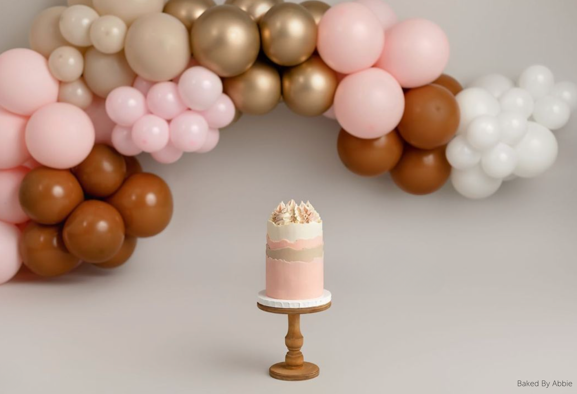 A pink cake stood on top of The Original Scandinavian Birch Cake Stand - Prop Options