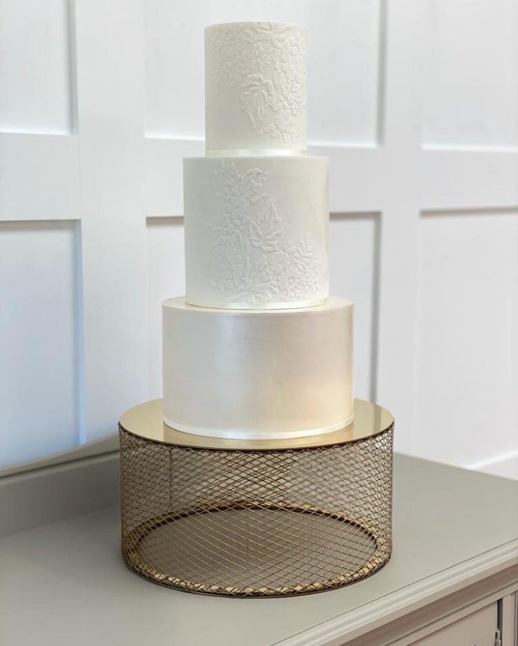 Gold metallic mesh cake stand with tiered wedding cake 
