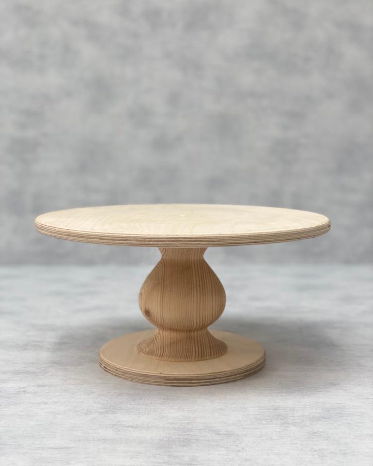 The Teardrop Scandinavian Birch Cake Stand in standard size and a natural finish - Prop Options